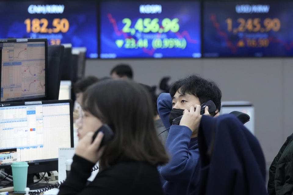 A currency trader watches monitors at the foreign exchange dealing room of the KEB Hana Bank headquarters in Seoul, South Korea, Monday, Feb. 6, 2023. Asian stock markets sank Monday after strong U.S. jobs data fanned fears of more interest rate hikes to cool inflation. (AP Photo/Ahn Young-joon)