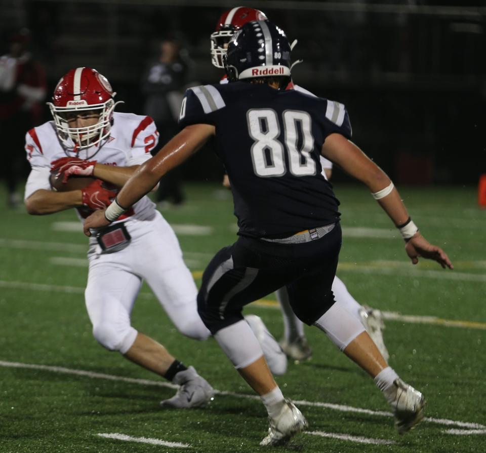 Exeter High School's Tyler Graney looks to make the tackle during Exeter's 28-7 loss to St. John's (Mass) on Friday night at Exeter High School.