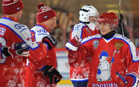 Russian President Vladimir Putin takes part in an exhibition match of the Night Hockey League on an ice rink at Red Square - Credit: ALEXEY DRUZHININ/AFP