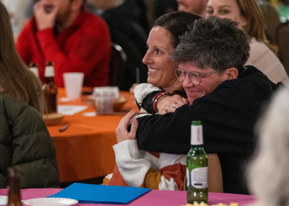 Kelly Kuhn (left), gets an embrace from friend Kim Duncan on Wednesday, Feb. 1, 2023, at an Indianapolis meeting for Catholic Allies, a new non-profit group of Catholics who seek to educate others about LGBTQ issues.