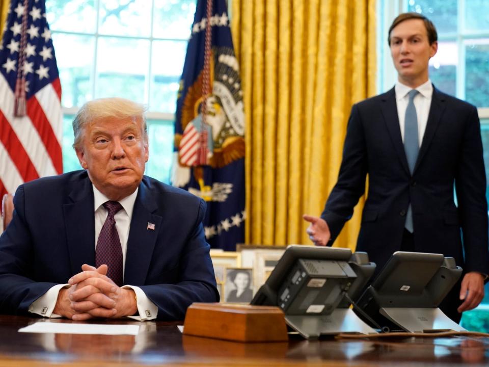 President Trump in the Oval Office with Jared Kushner speaking behind him.