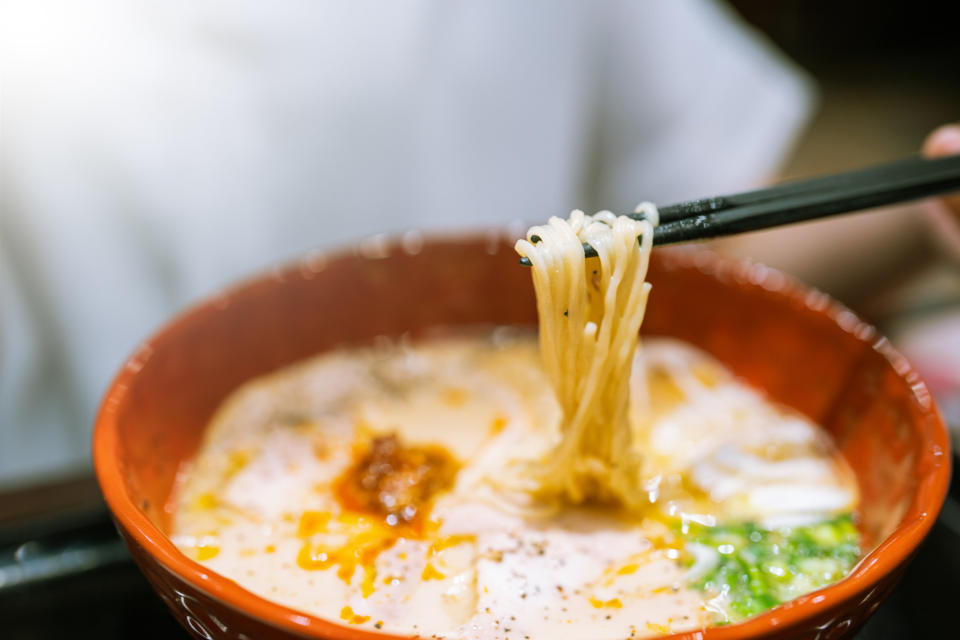 Close-up of ramen noodles in red bowl on table