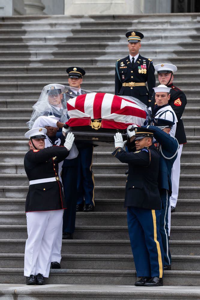 Joint service members of a military casket team carry the casket of Senator John McCain from the US Capitol to a motorcade that will ferry him to a funeral service at the National Cathedral
