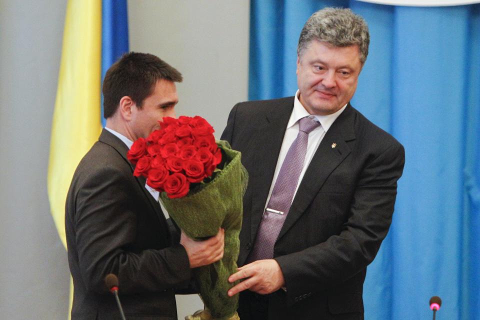 Ukraine's President Petro Poroshenko (R) presents flowers to newly appointed Foreign Minister Pavlo Klimkin during Klimkin's presentation to employees of the Ministry of Foreign Affairs, in Kiev June 19, 2014. The Ukrainian parliament on Thursday approved diplomat Pavlo Klimkin as foreign minister by a big majority following his nomination by President Petro Poroshenko. REUTERS/Valentyn Ogirenko (UKRAINE - Tags: POLITICS)