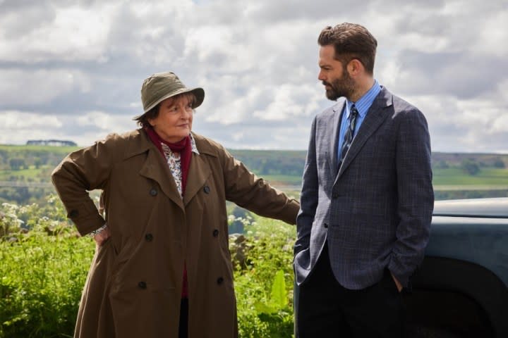 A woman talks to a man in Vera.