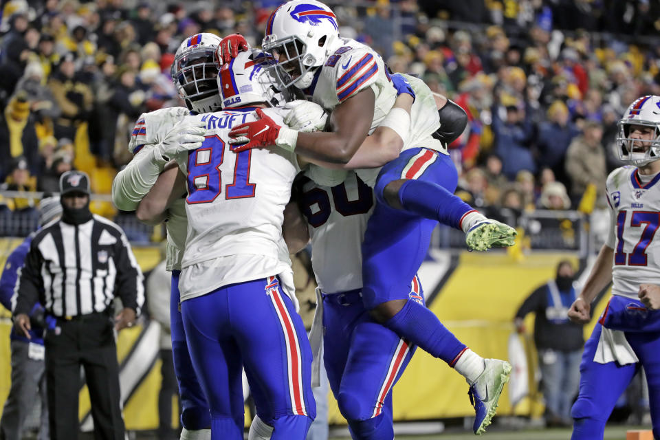 Buffalo Bills tight end Tyler Kroft (81) celebrates with running back Devin Singletary (26) and others after scoring on a pass from quarterback Josh Allen during the second half of an NFL football game against the Pittsburgh Steelers in Pittsburgh, Sunday, Dec. 15, 2019. (AP Photo/Don Wright)