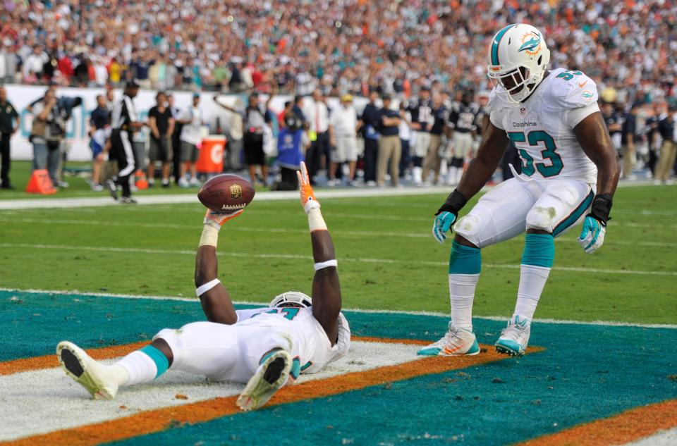 Safety Michael Thomas celebrates his interception in the end zone against Tom Brady.