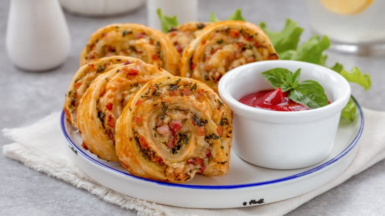 Pizza roll ups on plate with dip