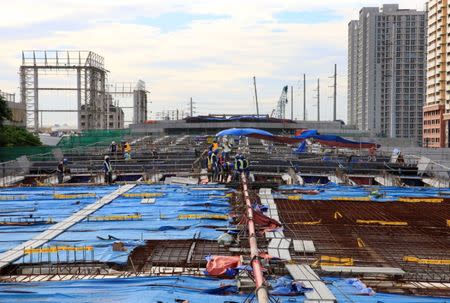 Workers lay out steel bars in constructing the 8-kilometer 4-lane elevated highway along Buendia avenue in Makati City, metro Manila, Philippines August 3, 2017. REUTERS/Romeo Ranoco