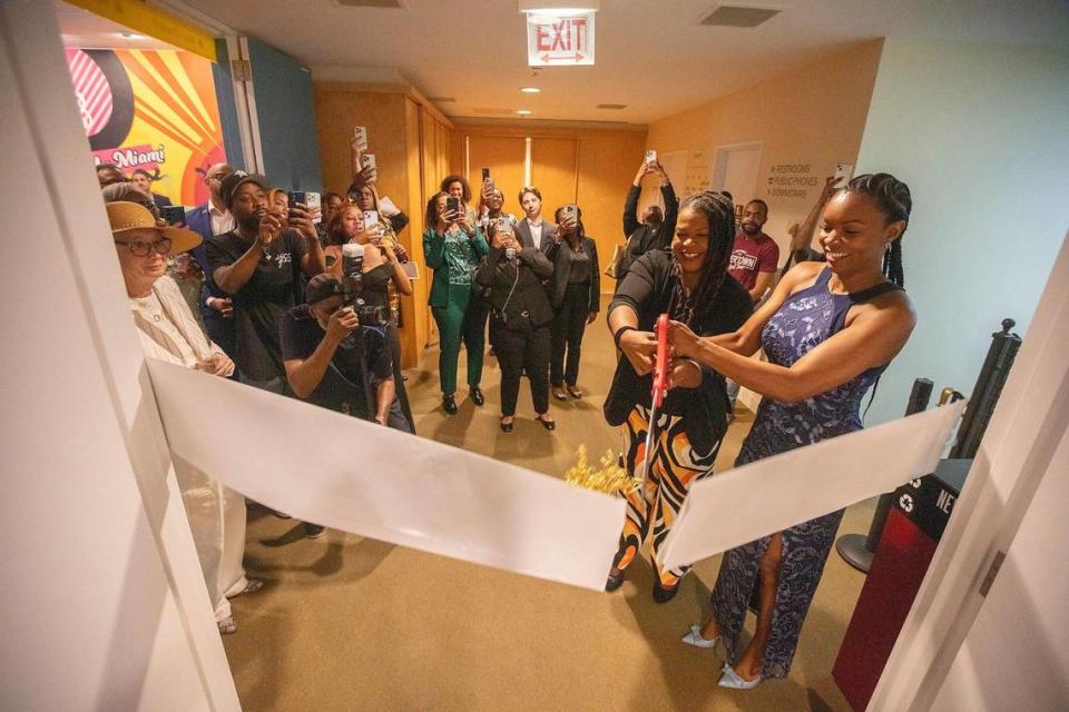 Kamila Pritchett (l), Executive Director of the Black Archives and Florida State Representative, Ashley V. Gantt (r), cut the ribbon at the opening of the Gwen Cherry exhibit.