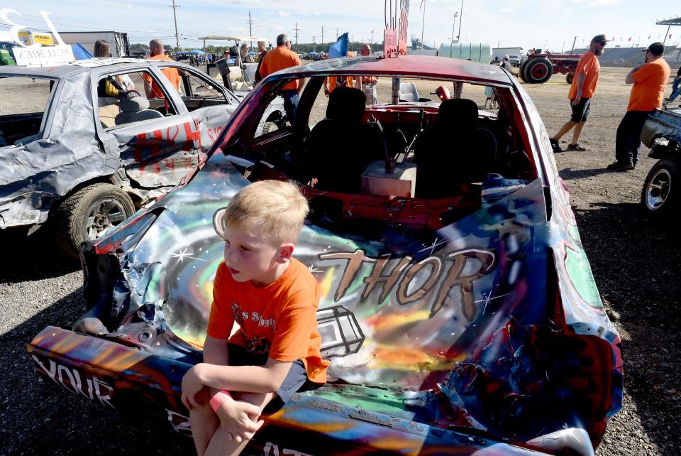 Beau Beaubien sits on the hood of the derby car built for his father, Craig, before the start of the  Best of Show contest.