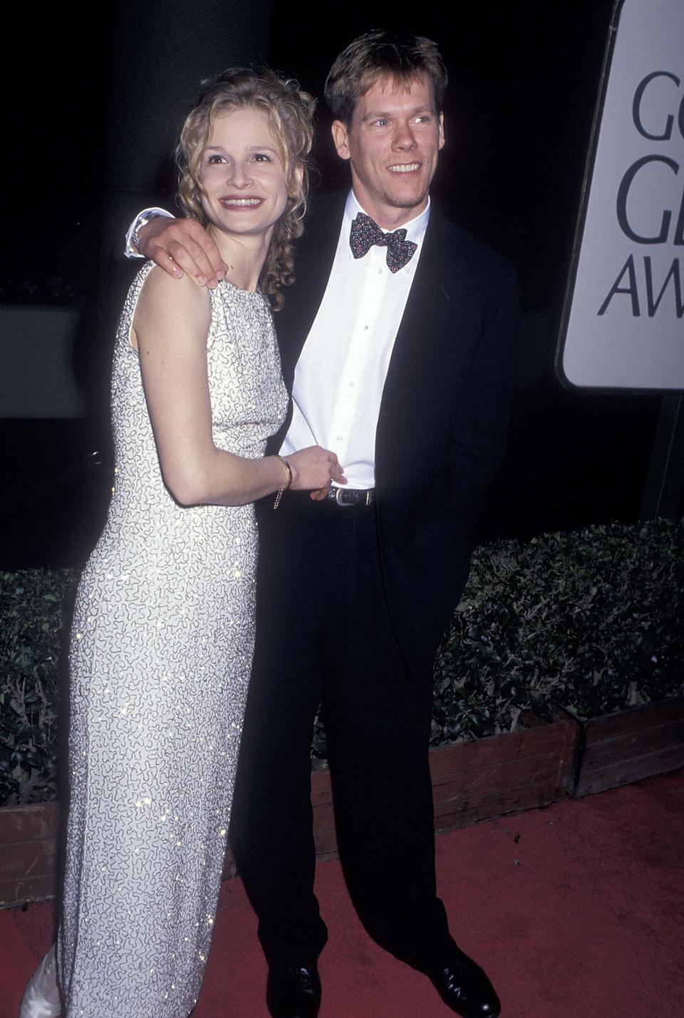 Kyra Sedgwick in a dress standing next to Kevin Bacon in a tuxedo