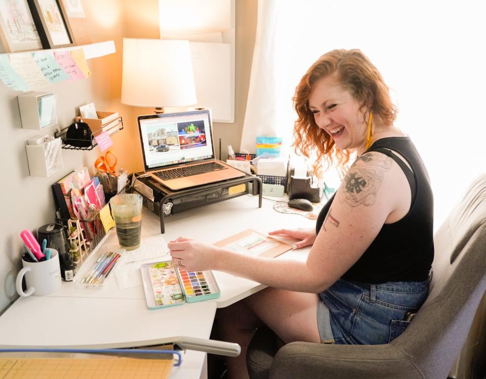 Artist Skye Lee Smith, who attended Herron School of Art + Design in Indianapolis, works on two architectural watercolor paintings, Thursday, July 28, 2022, at her Indianapolis home. Smith, who paints Indiana landmarks,  also takes commissions to paint private homes.