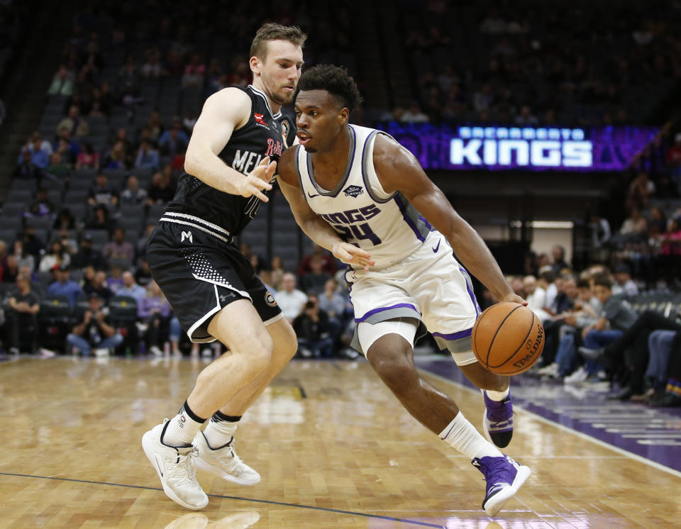 Sacramento Kings guard Buddy Hield, right, drives against Melbourne United guard Chris Goulding during the second half of an NBA exhibition basketball game in Sacramento, Calif., Wednesday, Oct. 16, 2019. The Kings won 124-110. (AP Photo/Rich Pedroncelli)