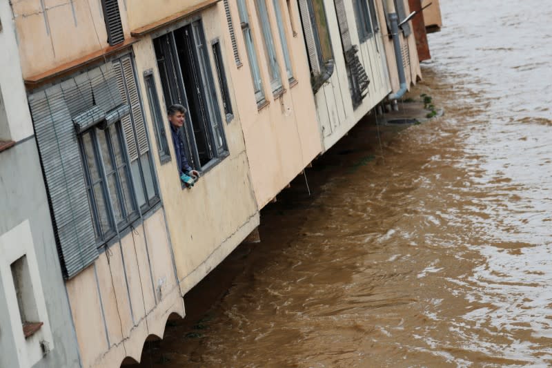 Worker looks at the high level of the Onyar river during the storm "Gloria" in Girona