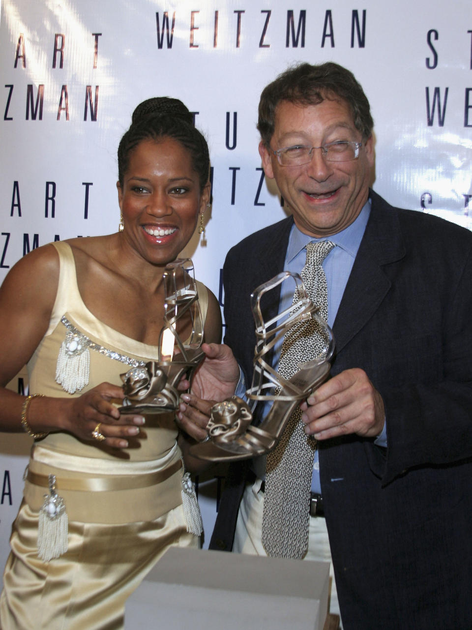 BEVERLY HILLS - FEBRUARY 24:(L-R) Actress Regina King and shoe designer Stuart Weitzman at the unveiling of the special shoes (2 pieces of Marilyn Monroe's jewels embedded in the satin) that she will be wearing to the Academy Awards, as she attends the Celebrity shoe Designer Stuart Weitzman annual Oscar dinner, at Christies Auction House on February 24, 2005 in Beverly Hills, California.  (Photo by Marsaili McGrath/Getty Images)