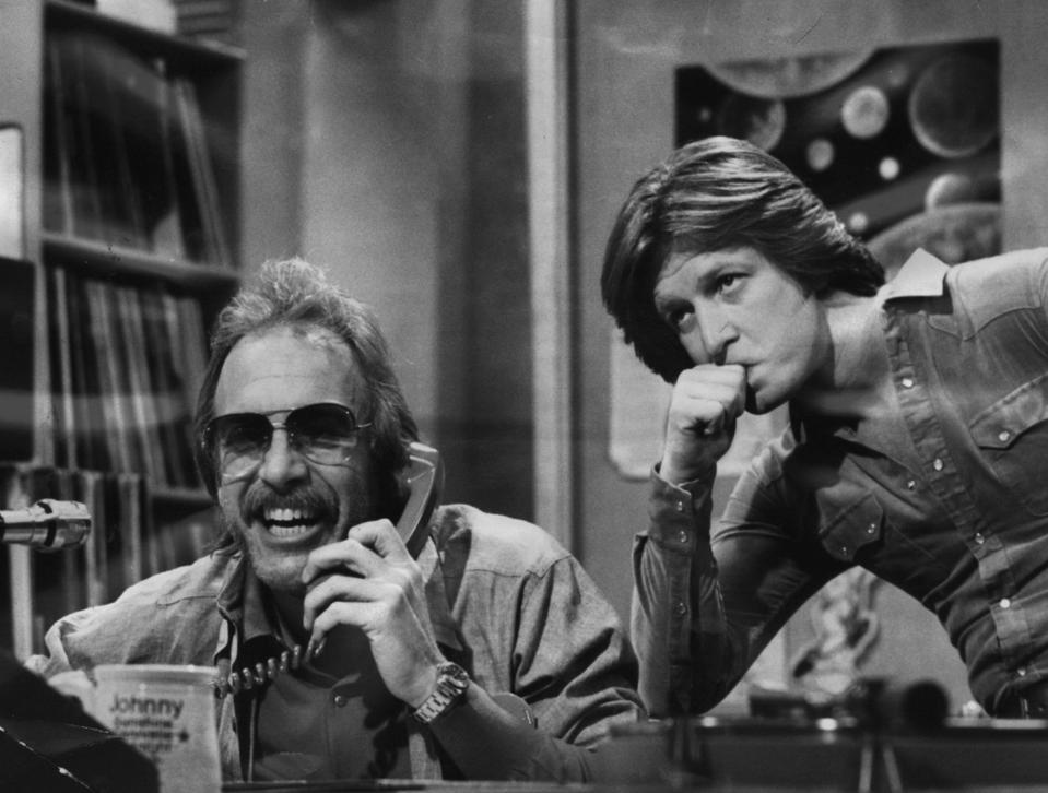 DJ Dr. Johnny Fever (Howard Hesseman, left) chats up a caller while program director Andy Travis (Gary Sandy) listens in on "WKRP in Cincinnati."