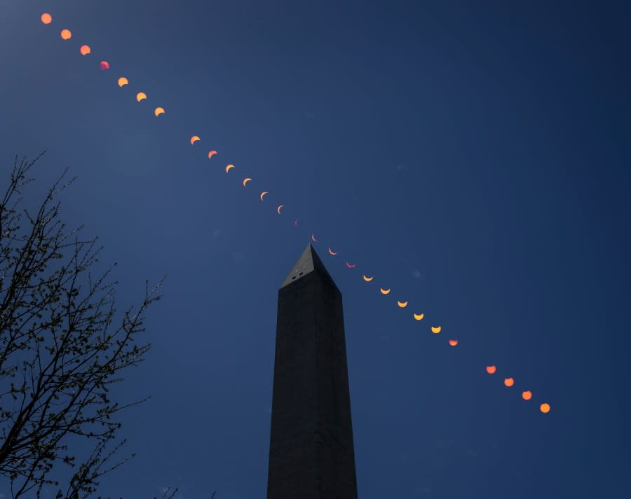 In this composite image by NASA, the Moon is seen passing in front of the Sun, with the top of the Washington Monument in silhouette, during a partial solar eclipse April 8, 2024 in in Washington, DC. (Photo by Bill Ingalls/NASA)