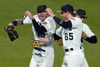 Pittsburgh Pirates outfielders Ben Gamel, left, Jack Suwinski (65), and Bryan Reynolds, rear, celebrate after getting the final out of win over the Colorado Rockies in a baseball game in Pittsburgh, Monday, May 23, 2022. (AP Photo/Gene J. Puskar)