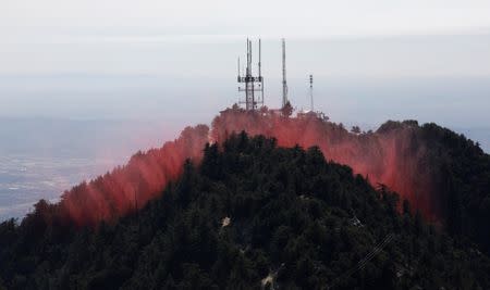 Fire retardant is dropped while battling the Wilson Fire near Mount Wilson in the Angeles National Forest in Los Angeles, California, U.S. October 17, 2017. REUTERS/Mario Anzuoni