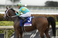 Jockey Irad Ortiz, Jr. reacts aboard Atone after winning the Pegasus World Cup Turf Invitational horse race, Saturday, Jan. 28, 2023, at Gulfstream Park in Hallandale Beach, Fla. (AP Photo/Lynne Sladky)