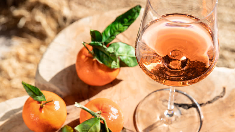 Glass of rosé and oranges