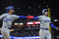 Los Angeles Dodgers' Mookie Betts, left, and Freddie Freeman celebrate after they scored against the San Francisco Giants on Will Smith's double during the 10th inning of a baseball game Monday, May 13, 2024, in San Francisco. (AP Photo/Godofredo A. Vásquez)