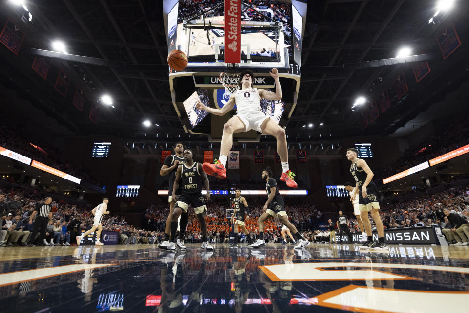 Virginia's Blake Buchanan (0) celebrates after dunking the ball during the second half of an NCAA college basketball game against Wake Forest Saturday, Feb. 17, 2024 in Charlottesville, Va. (AP Photo/Mike Kropf)