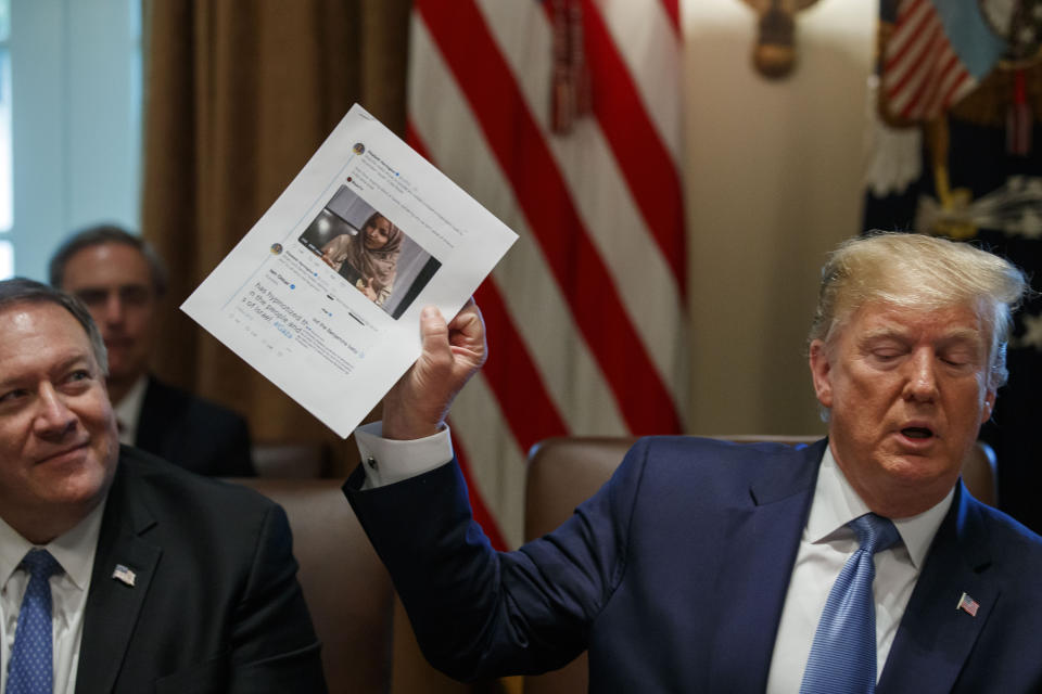 Secretary of State Mike Pompeo, left, looks at a paper held by President Donald Trump about Rep. Ilhan Omar, D-Minn., as Trump speaks during a Cabinet meeting in the Cabinet Room of the White House, Tuesday, July 16, 2019, in Washington. (AP Photo/Alex Brandon)