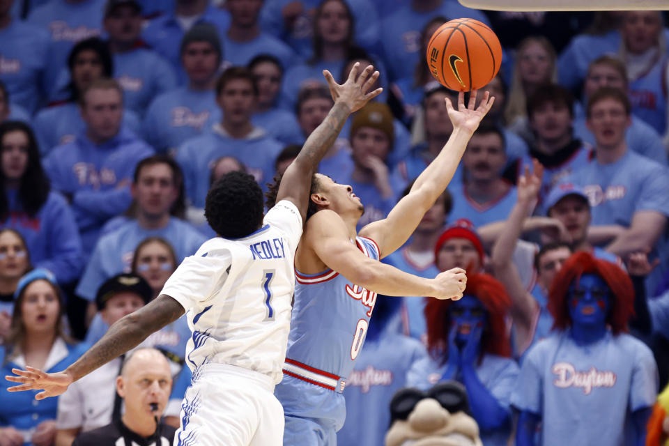 Dayton guard Javon Bennett, right, shoots in front of Saint Louis guard Cian Medley during the first half of an NCAA college basketball game in Dayton, Ohio, Tuesday, Jan. 16, 2024. (AP Photo/Paul Vernon)