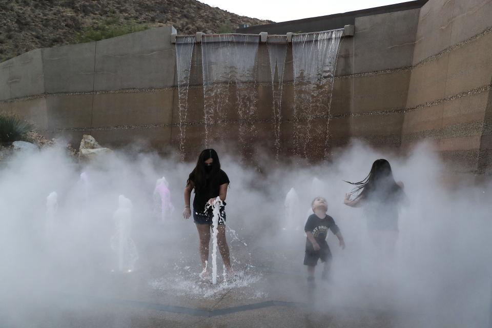 Children play in the water feature at the new park in downtown Palm Springs on October 21, 2021. The water feature is no longer working, the city says.