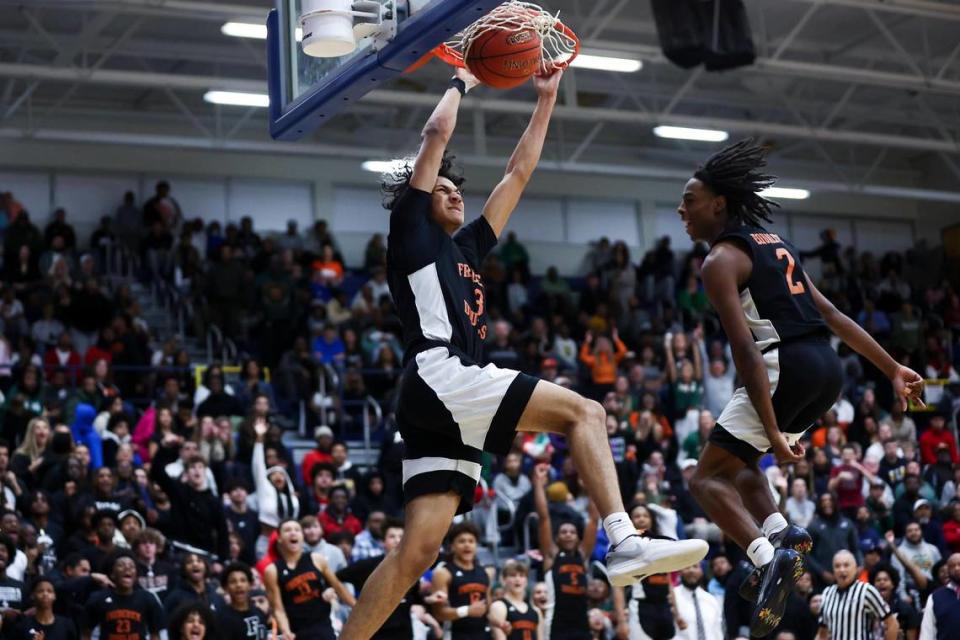 Frederick Douglass guard DeMarcus Surratt (3) dunks on a fast break as teammate Aveion Chenault trails the play in the second half of their game against Bryan Station during the 42nd District Tournament championship game at Henry Clay High School on Friday.