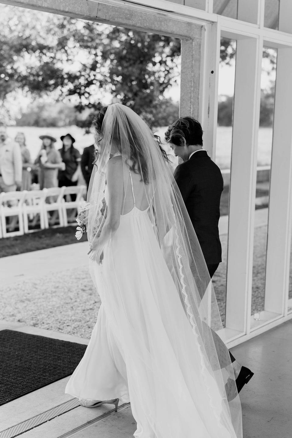 brides walking down processional aisle together