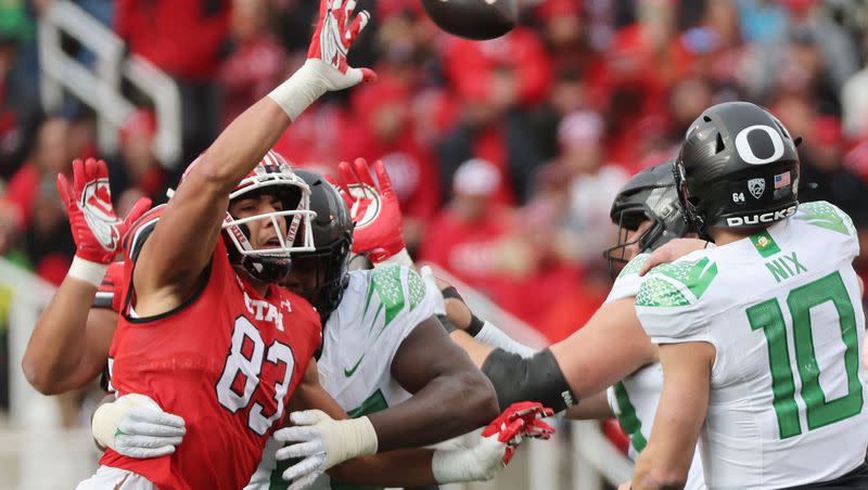 Utah defensive end Jonah Elliss (83) tries to block the pass by Oregon quarterback Bo Nix in Salt Lake City on Saturday, Oct. 28, 2023. Elliss went on to become a 2023 consensus All-American.