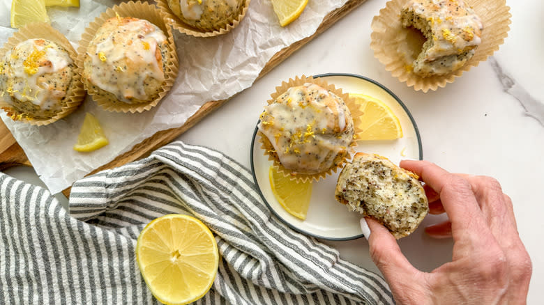 hand holding iced lemon poppy seed muffin