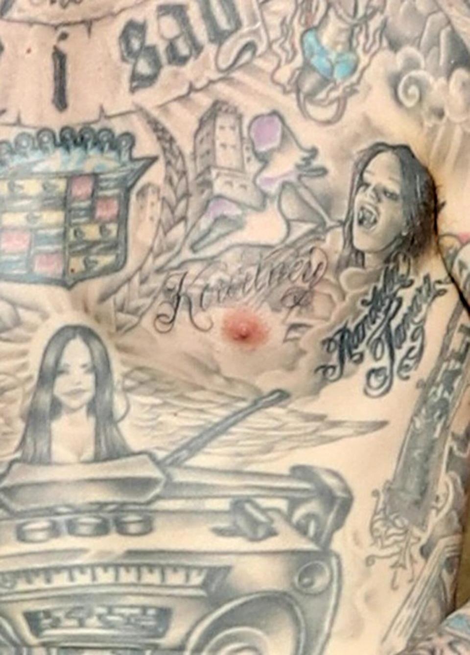 Travis Barker seen sporting a new Kourtney Tattoo over his heart as he plays the drums for a video on top a Hollywood tour bus