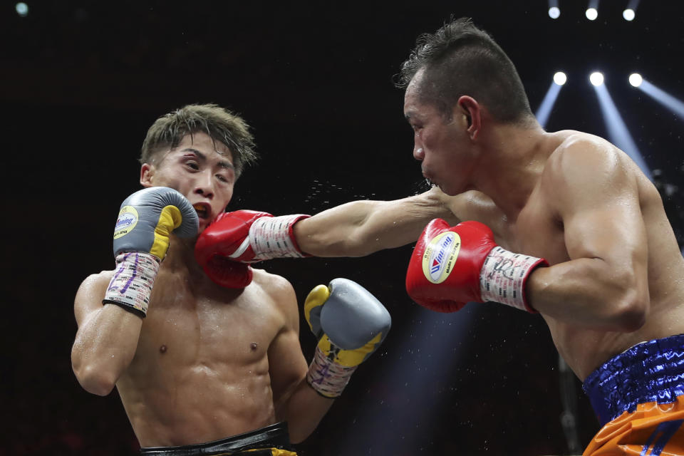 Philippines' Nonito Donaire, right, sends a right to Japan's Naoya Inoue in the fifth round of their World Boxing Super Series bantamweight final match in Saitama, Japan, Thursday, Nov. 7, 2019. Inoue beat Donaire with a unanimous decision to win the championship. (AP Photo/Toru Takahashi)