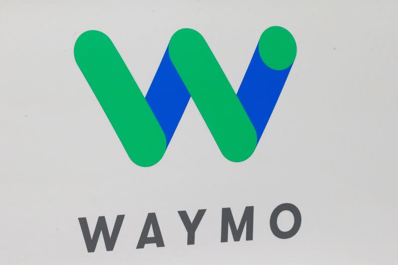 The Waymo logo is displayed during the company's unveil of a self-driving Chrysler Pacifica minivan during the North American International Auto Show in Detroit