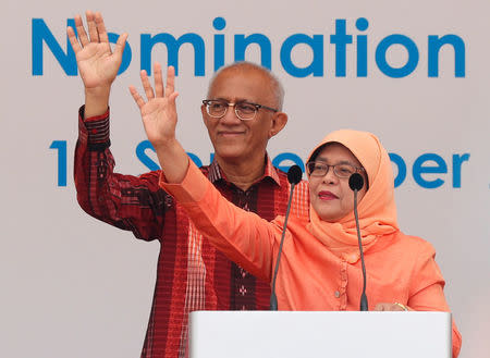 Singapore's President-elect Halimah Yacob and her husband Mohammed Abdullah Alhabshee address supporters before leaving the nomination centre in Singapore September 13, 2017. REUTERS/Edgar Su