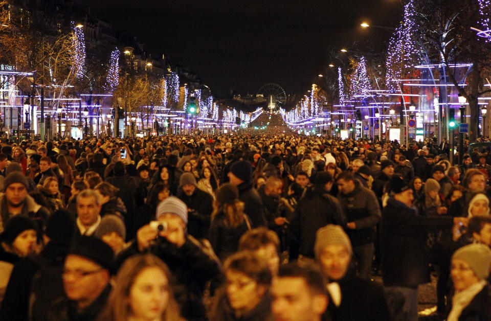 Revellers celebrate the New Year's Eve on the Champs Elysees avenue in Paris, France, Wednesday Jan. 1, 2014.(AP Photo/Remy de la Mauviniere)