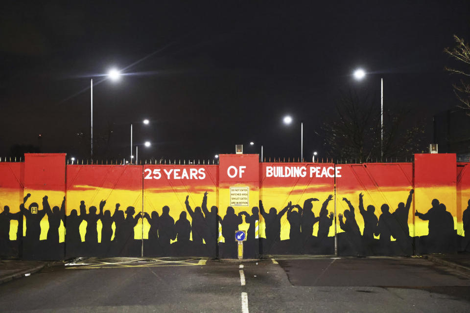 A mural on the peace gates at Lanark Way celebrates the Good Friday Agreement, in west Belfast, Wednesday, April 5, 2023. It has been 25 years since the agreement largely ended a conflict in Northern Ireland that left 3,600 people dead. (AP Photo/Peter Morrison)