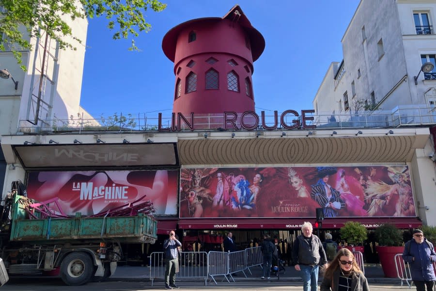 The Moulin Rouge (Red Mill) cabaret is seen Thursday April 25, 2024 in Paris. The windmill from the Moulin Rouge, the 19th century Parisian cabaret, has fallen off the roof overnight along with some of the letters in its name. (AP Photo/Oleg Cetinic)