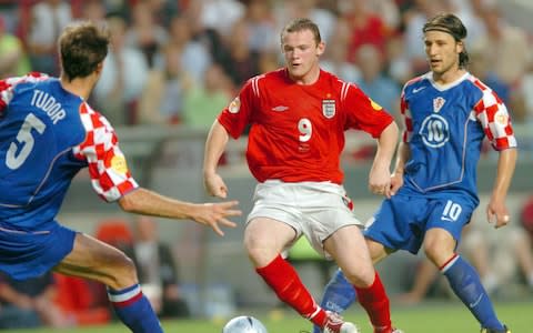 England's Wayne Rooney is challenged by Croatians Igor Tudor and Niko Kovac during their Group B match as part of the European Soccer Championship at the Stadium of Light in Lisbon, Portugal, Monday 21 June 2004 - Credit: EPA