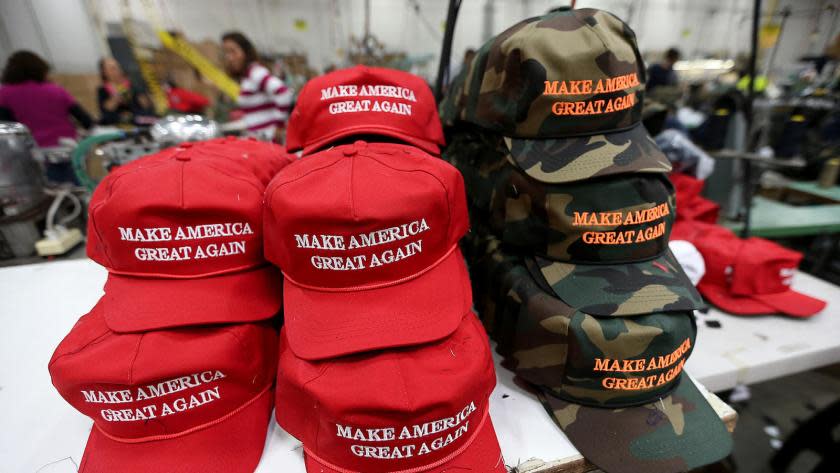 Full caption: CARSON, CALIF. NOV. 21, 2015 - Workers stitch together hats on the factory floor of Cali Fame and Cali Headwear in Carson. The hat and apparel maker is best known for producing Donald Trump's "Make America Great Again" baseball caps.