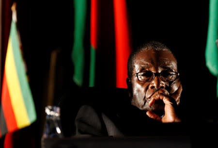 FILE PHOTO: Zimbabwean President Robert Mugabe watches a video presentation during SADC in Johannesburg