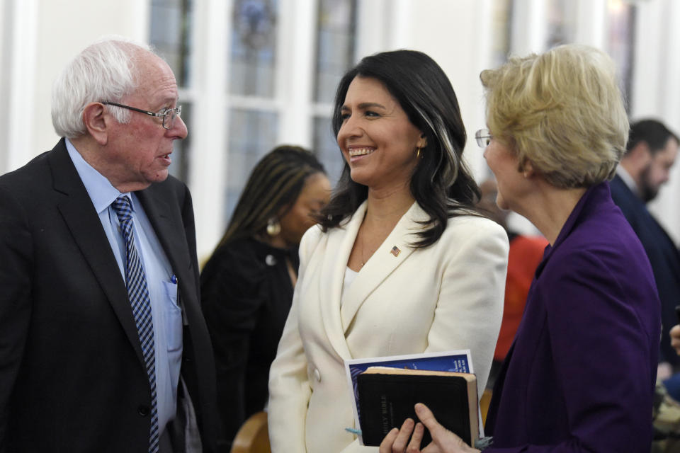 US. Sen. Bernie Sanders, left, I-Vt.,greets U.S. Rep. Tulsi Gabbard, center, D-Hawaiiand Sen. Elizabeth Warren, right, D--Mass., speak at a Martin Luther King Jr. Day services at Zion Baptist Church, Monday, Jan. 20, 2020, in Columbia, S.C. (AP Photo/Meg Kinnard)