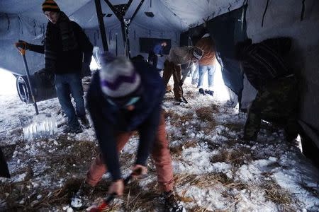 Veterans work to prepare a large sleeping tent inside of the Oceti Sakowin camp as "water protectors" continue to demonstrate against plans to pass the Dakota Access pipeline near the Standing Rock Indian Reservation, near Cannon Ball, North Dakota, U.S., December 3, 2016. REUTERS/Lucas Jackson