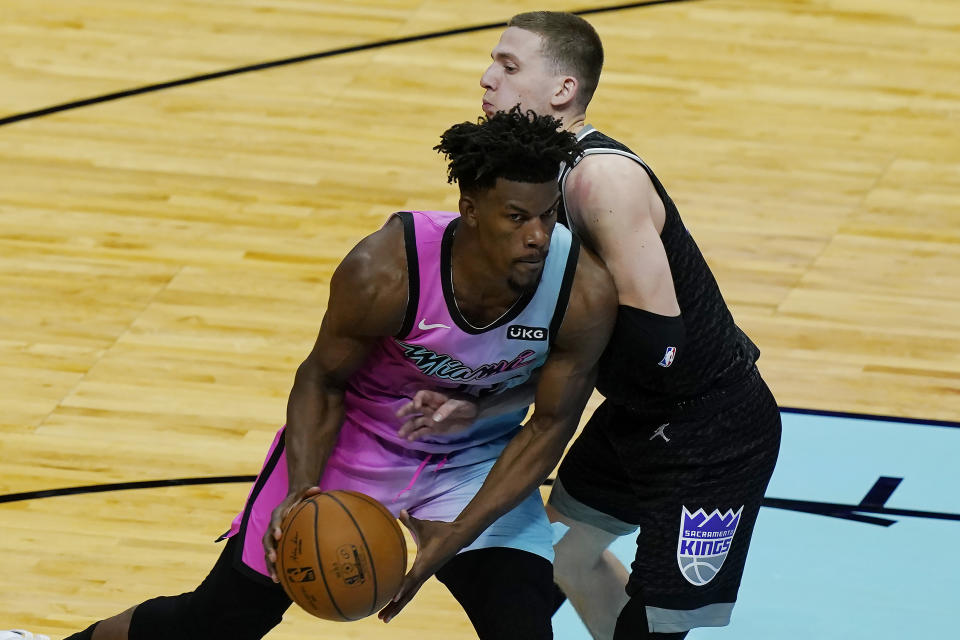 Sacramento Kings guard Kyle Guy (7) defends Miami Heat forward Jimmy Butler (22) during the second half of an NBA basketball game, Saturday, Jan. 30, 2021, in Miami. (AP Photo/Marta Lavandier)
