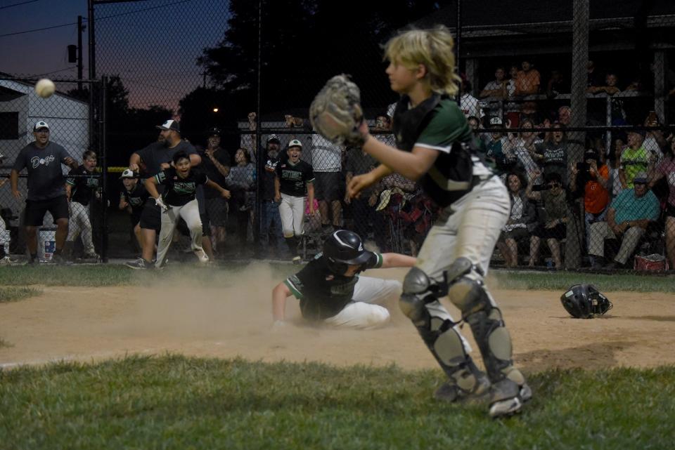 Mattingly Landscape's Joey Krupp scores the game- winning run, defeating North Newark Little League rival Edward Jones 6-5 to win in the Varsity Division championship in the 77th Licking County Shrine Tournament at Mound City.