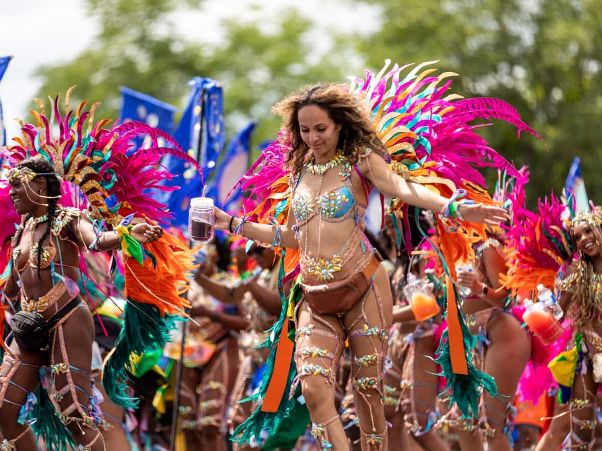 Scenes of dancers in costumes from the 55th Toronto Caribbean Carnival's Grand Parade at the Exhibition Place on July 30, 2022. (Sabah Rahman/CBC - image credit)
